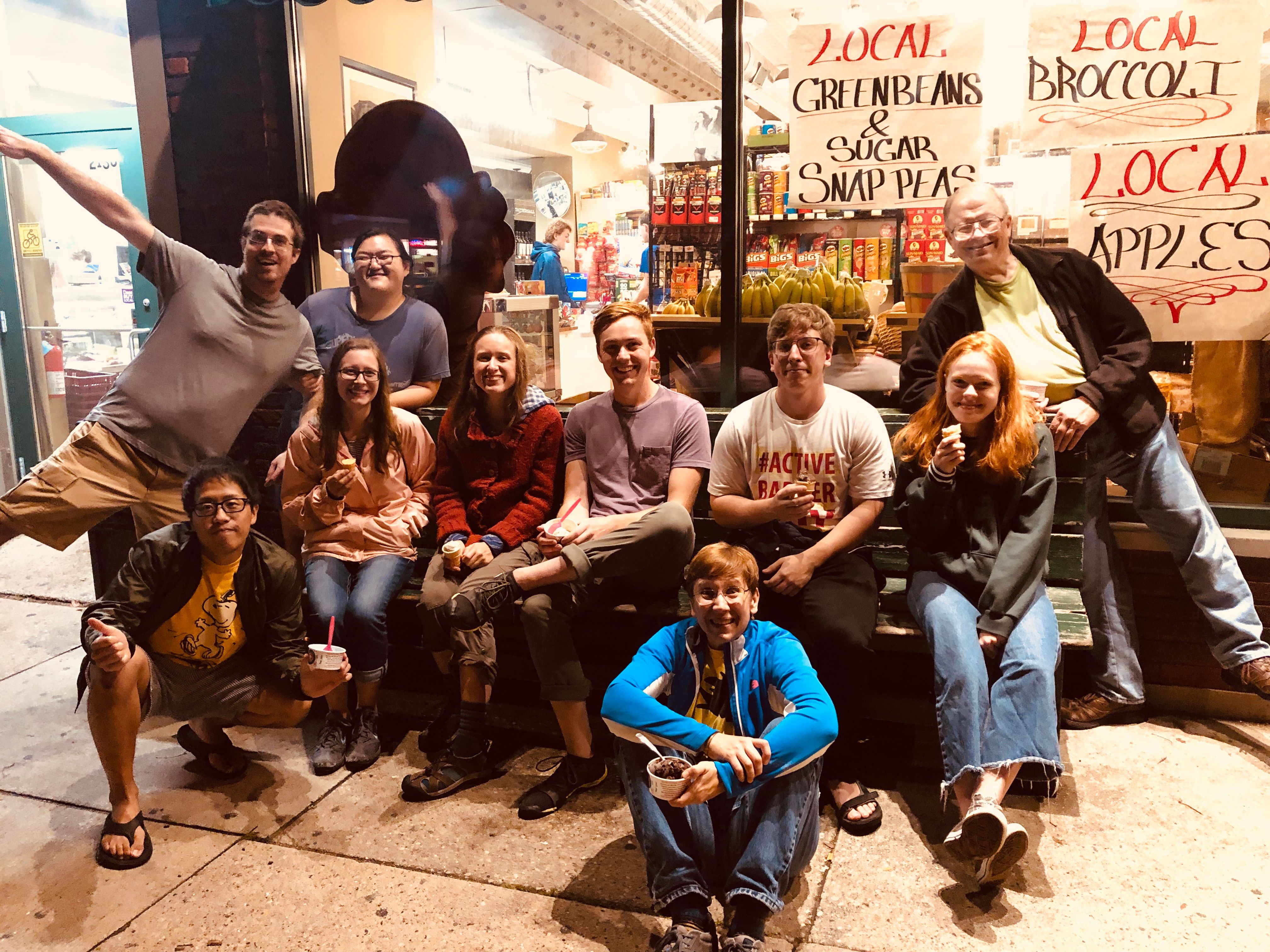 Summiteers buy ice cream at Regent Street Market after a house meeting. Group poses for a photo in front of the store. (Circa fall 2019)