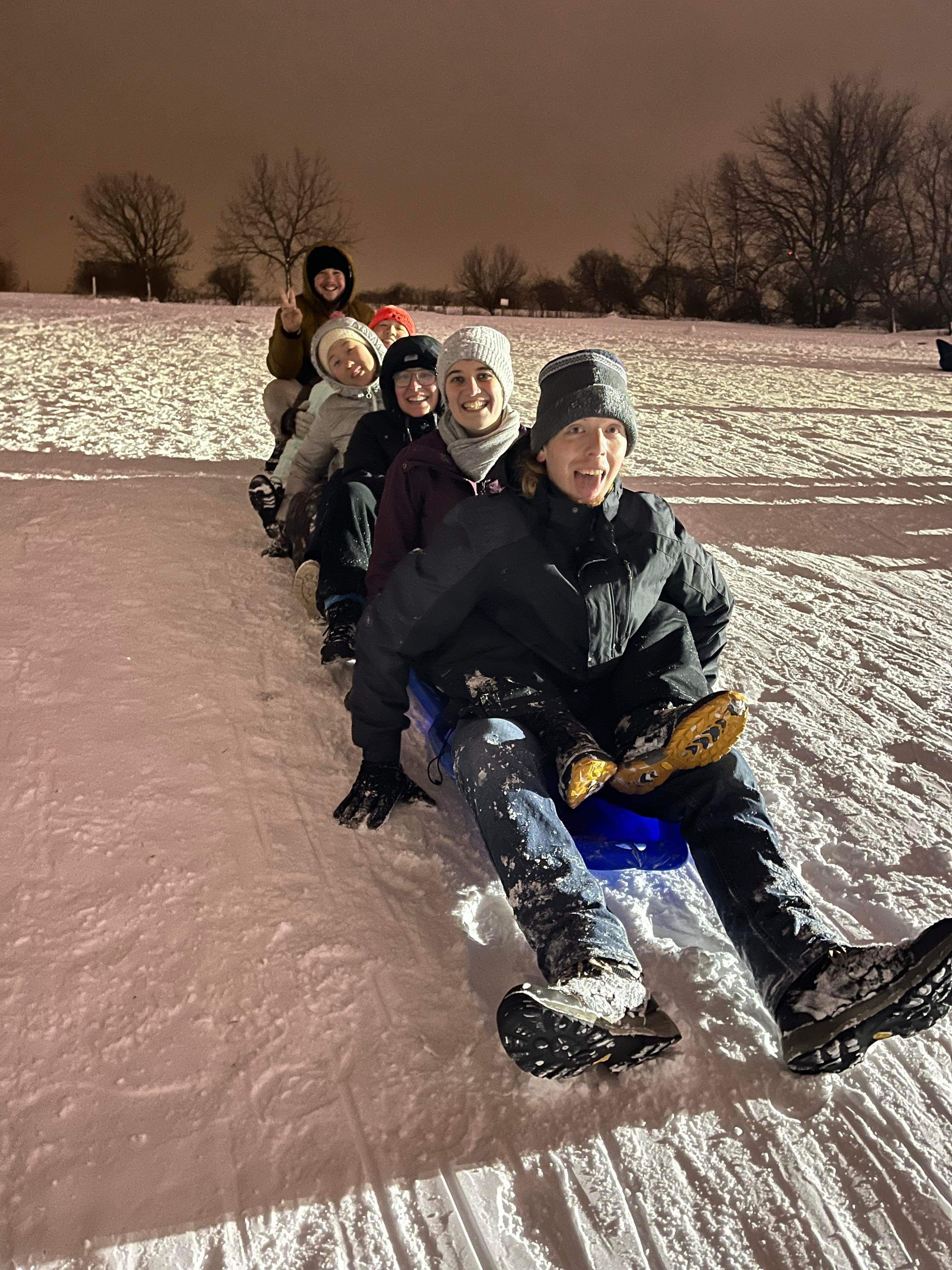 Six Summiteers form a sledding train (January 2024)
